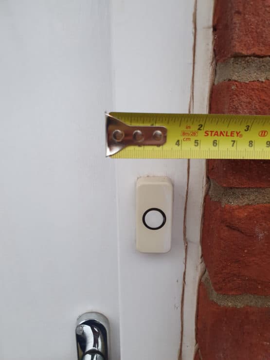 A measuring tape held up to show the door frame width: which is a bit less than 2.5" from start to the wall.