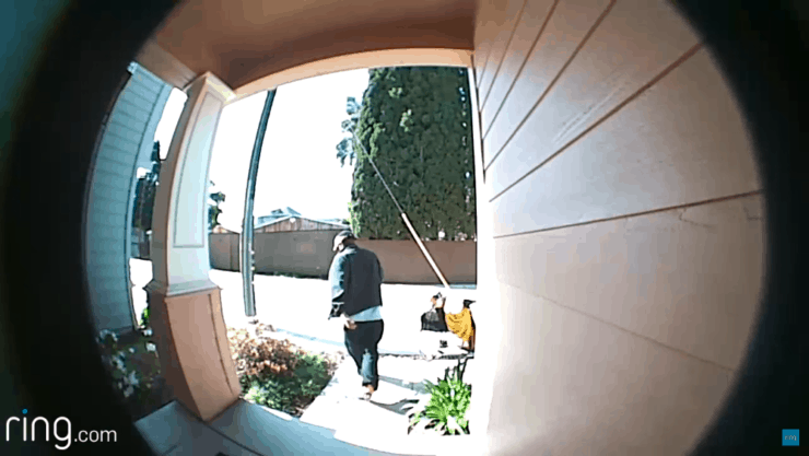The back of someone leaving a property, as captured by a Ring Doorbell 1 device.