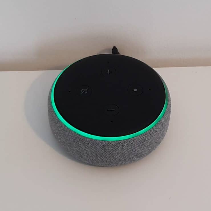 An Echo Dot 3rd gen in calling mode (i.e. with a green ring around it)