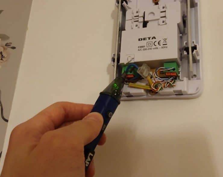 Using a voltage pen or similar device to check that I've successfully turned off the electric supply to the Deta doorbell unit.