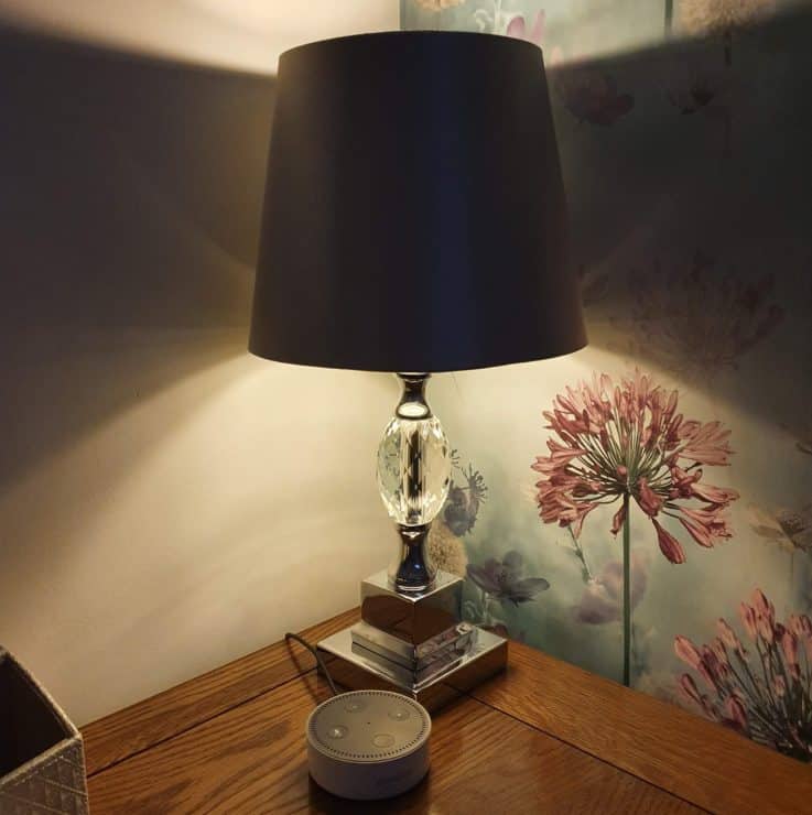 A side lamp with an Amazon Echo Dot in-front of it