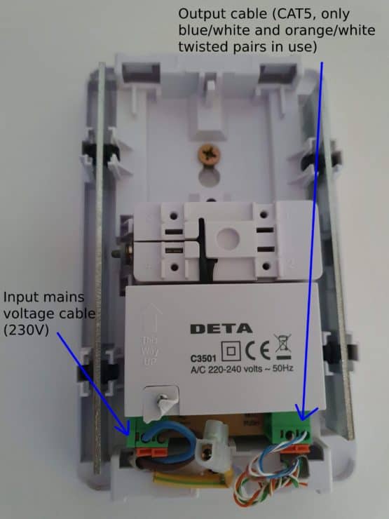 A labelled Deta C3501 doorbell transformer/chime wall-mounted unit, showing the incoming 230V cable on the bottom left and the outgoing CAT5 cable on the bottom right.