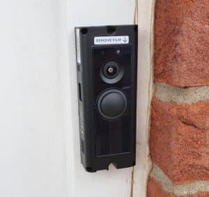 A Ring Pro attached to a door frame, but without the faceplate - or power being supplied to it (yet).