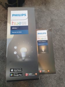 The boxes for the Philips Hue B22 Starter Kit and the Philips Hue White Ambiance E14 bulbs, both of which say "ZigBee Certified product" on their side.