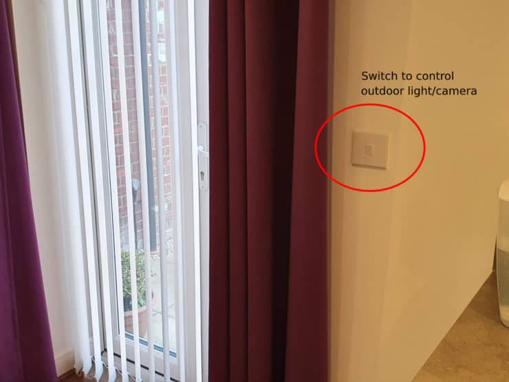 A wall switch by my back door which controls an outdoor light (but could control a Ring camera or other smart device).