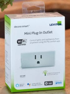 A marketing image of the Leviton DW15P-1BW smart plug