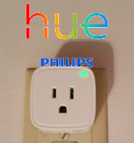 A Innr smart plug, with the "hue PHILIPS" logo text overlayed over it.