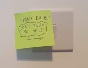 A sticky note put over a standard wall switch, saying "Smart bulb!!! Don't turn me off!!!"