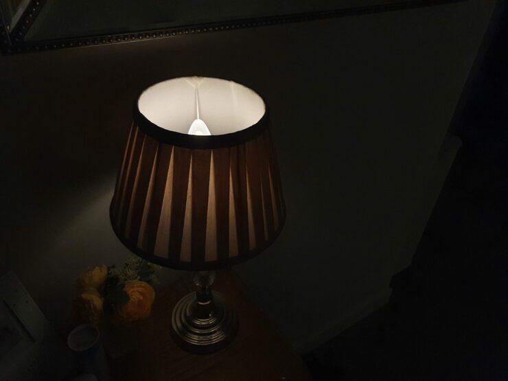 A table lamp with Philips Hue E14 candle bulb, dimmed to 1% brightness