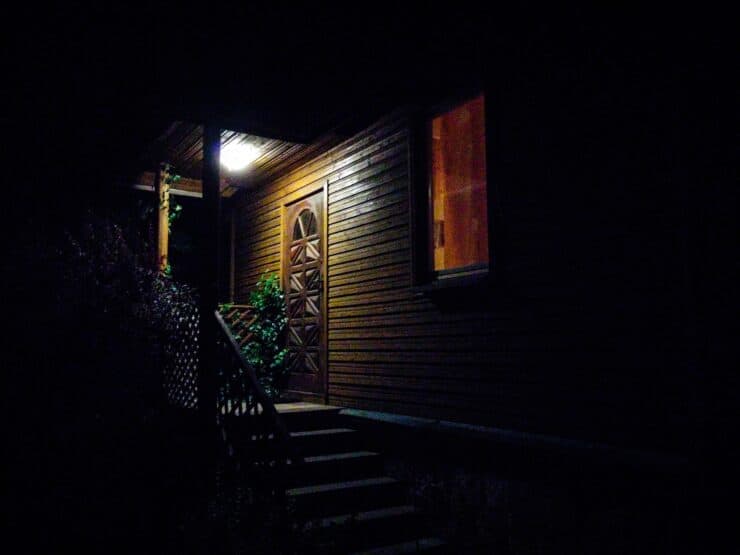 A veranda/porch with an overhead light turned on.