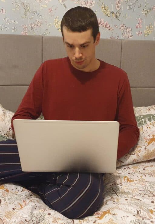 Me working on my laptop in my bedroom
