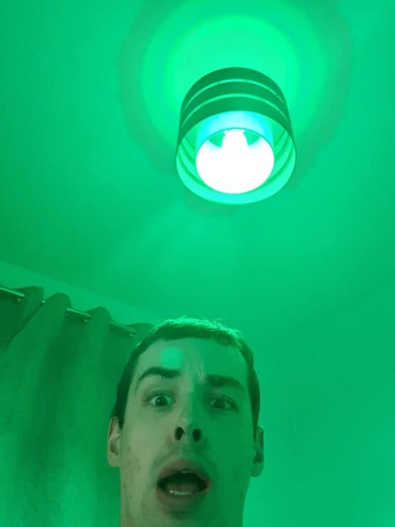 A LIFX bulb with green light and me taking a selfie