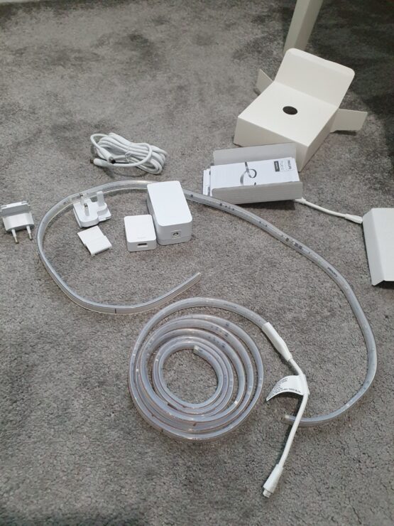 The various parts of a Philips Hue Lightstrip V4 base and extension kit