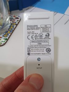The back of the Hue dimmer switch showing the battery cover and setup button