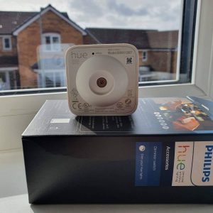 A Hue motion sensor pointed at a window/glass