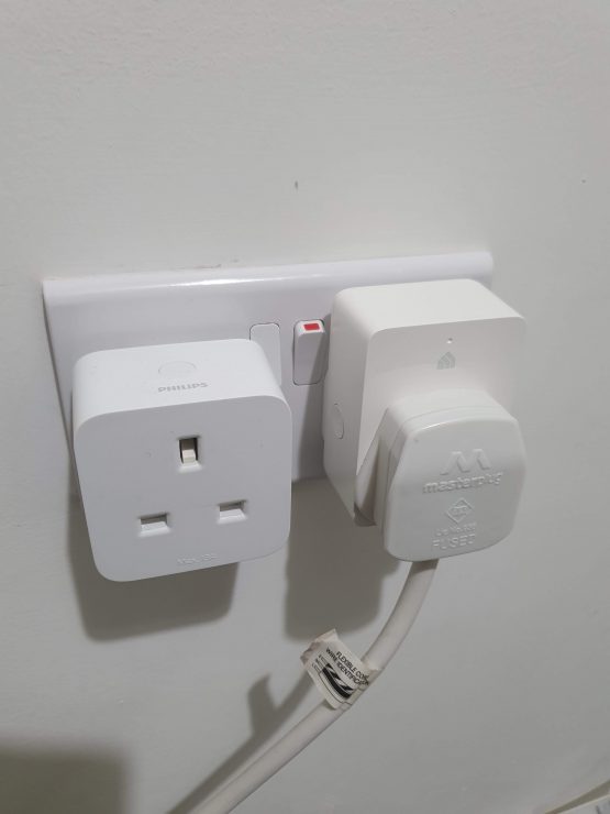 Two smart plugs Hue and Kasa side by side