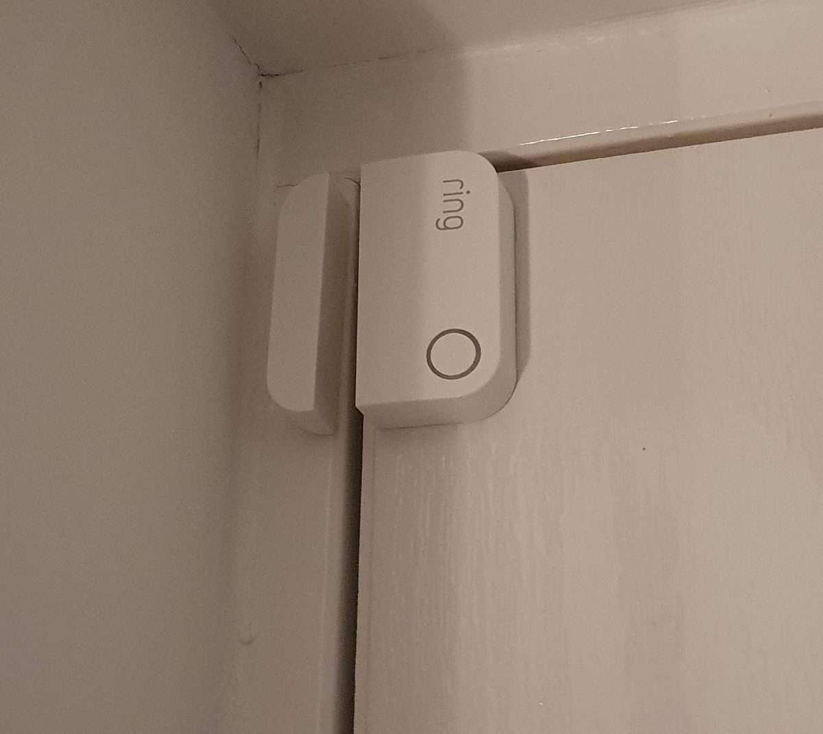 https://www.smarthomepoint.com/wp-content/uploads/2021/10/A-Ring-Contact-Sensor-installed-on-my-front-door.jpg