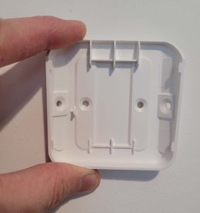 The four screw holes of the Ring Motion Sensor back plate