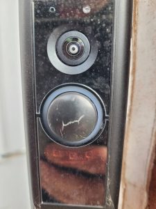 A partially cracked Ring Doorbell Pro button