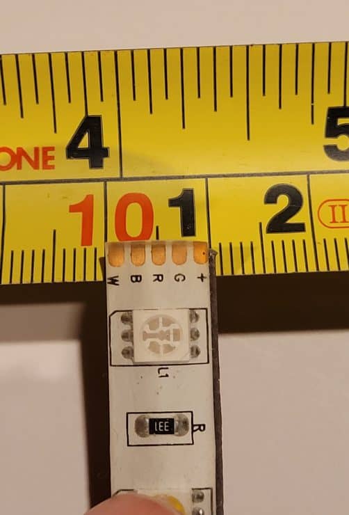 A 5 pin LED lightstrip on a tape measure showing its 10mm width