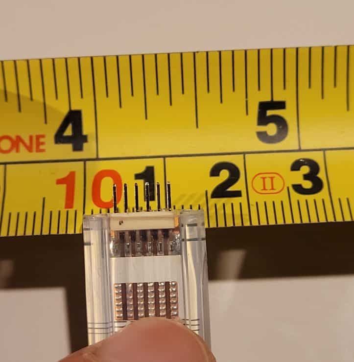 A 6 pin Hue Lightstrip on a tape measure showing its 14mm width