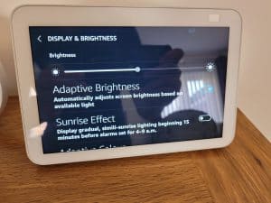 The brightness slider adaptive brightness and sunrise effect options on an Echo Show 8