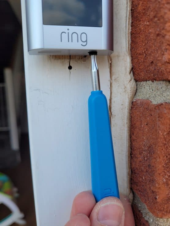 Changing the faceplate of a Ring Doorbell by unscrewing the security screw in the bottom