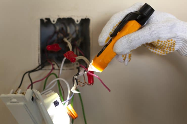 Examining the wiring behind a light switch