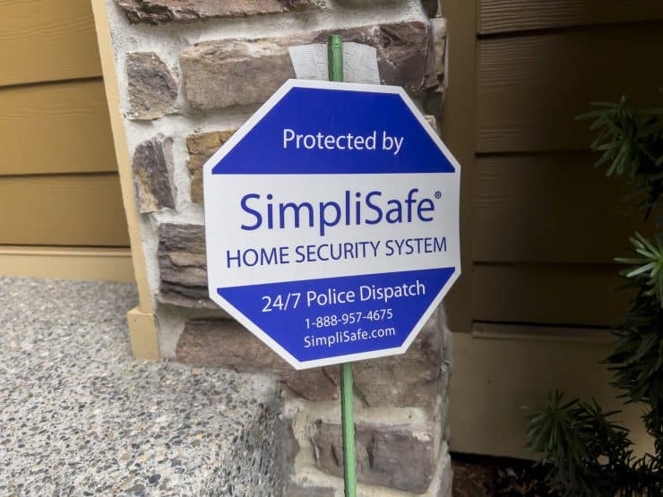 A protected by Simplisafe sign outside someones home